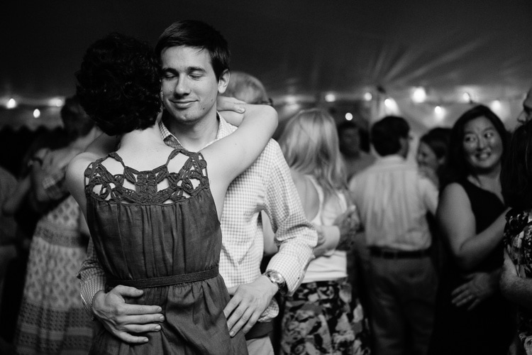 guests slow dance at a tented wedding reception