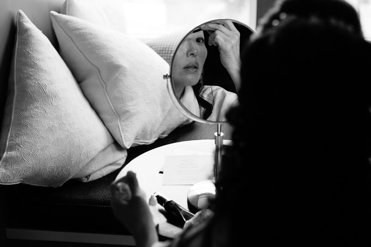 bride applies make-up in a suite at the Hotel Commonwealth