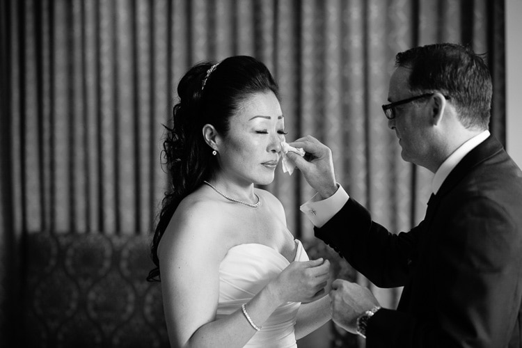 emotional first look, groom wipes away bride's tears