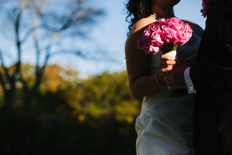 sun falls on the bride's bouquet in the gardens of alden castle