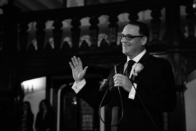 groom welcomes guests at Alden Castle