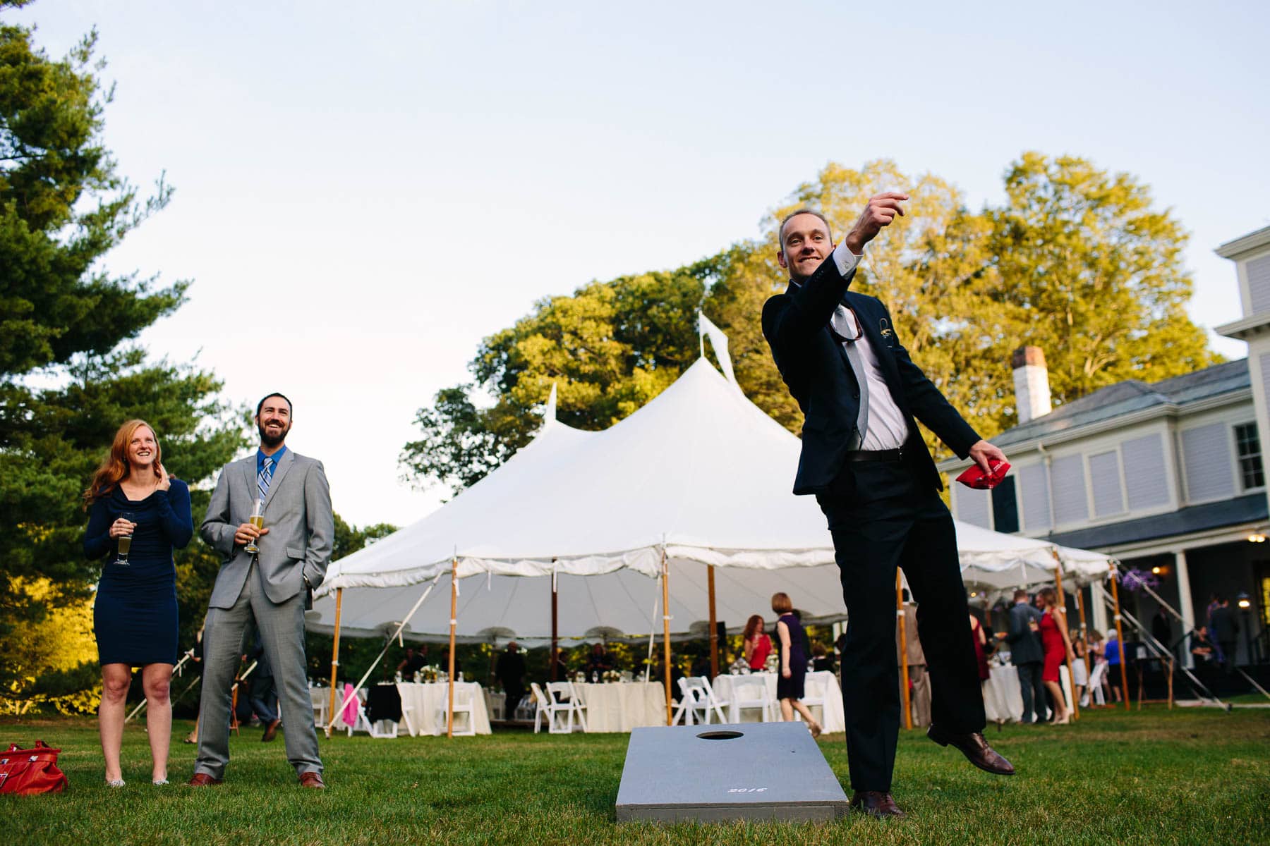 outdoor cocktail hour at Lyman Estate wedding with reception tent