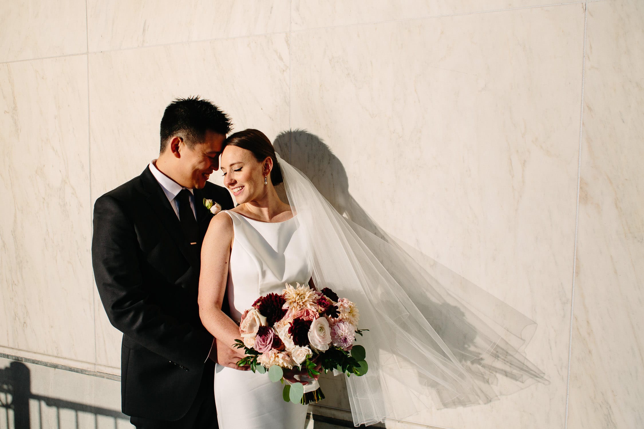 bride leans into groom during romantic photojournalistic portrait session