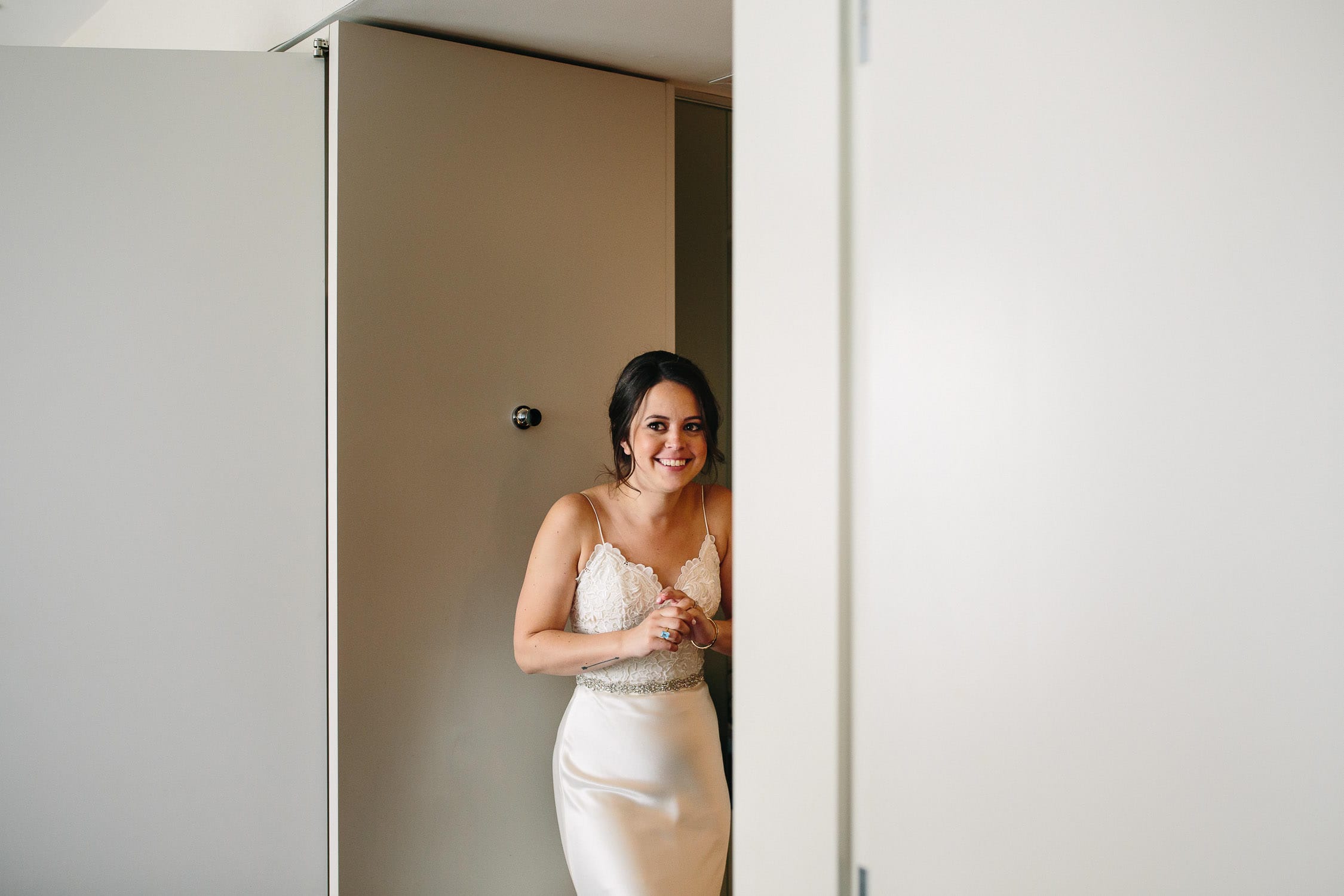 photo of bride joyfully peeking into the room