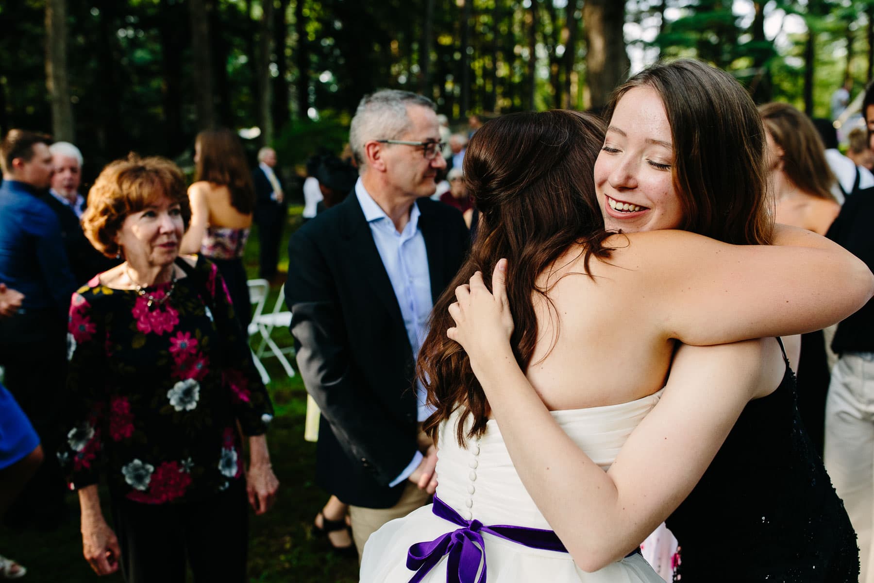 post wedding ceremony hugs at a backyard wedding in Northampton MA | Kelly Benvenuto Wedding Photography