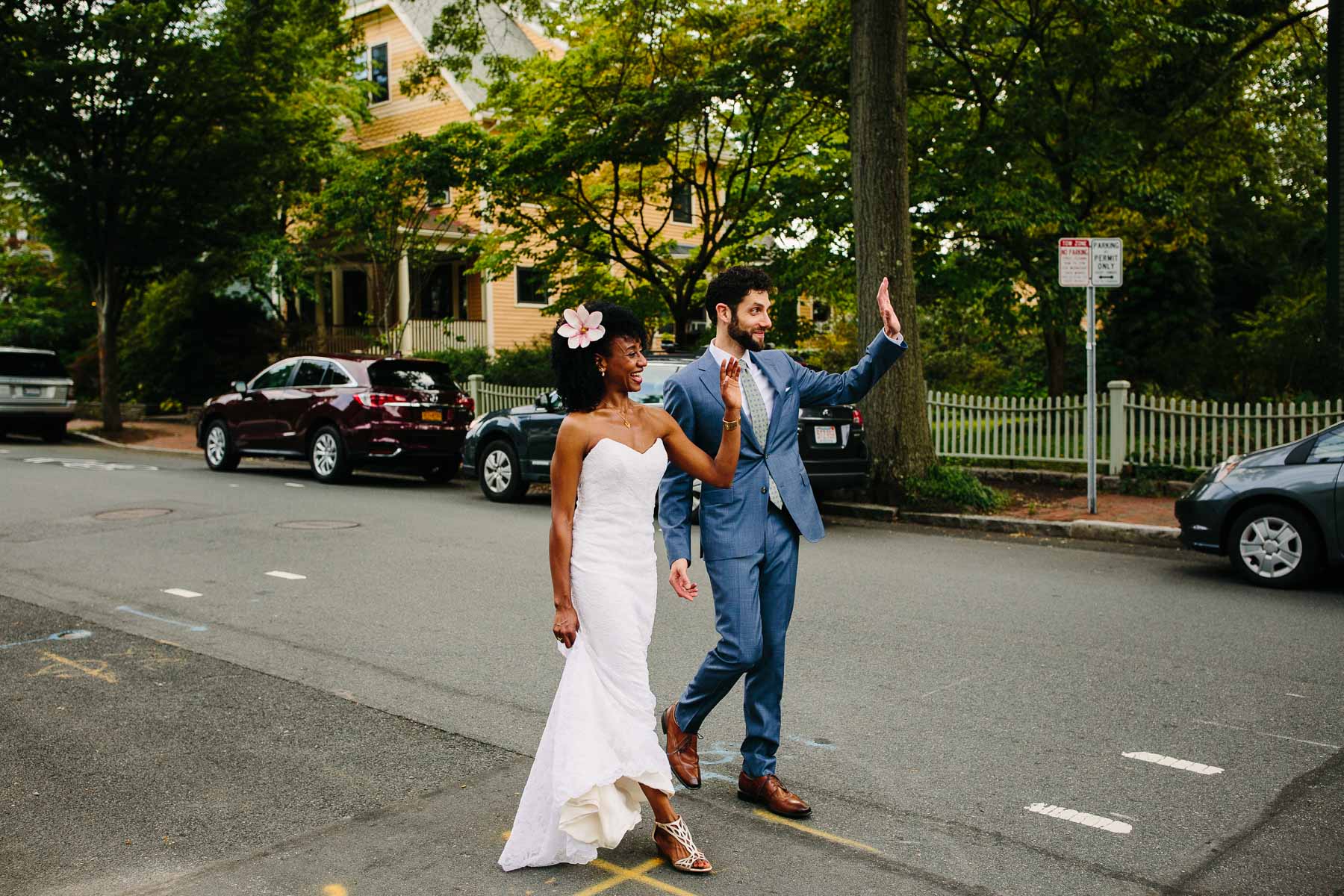 bride and groom walk and wave  to neighbors in Cambridge, MA | Kelly Benvenuto Photography