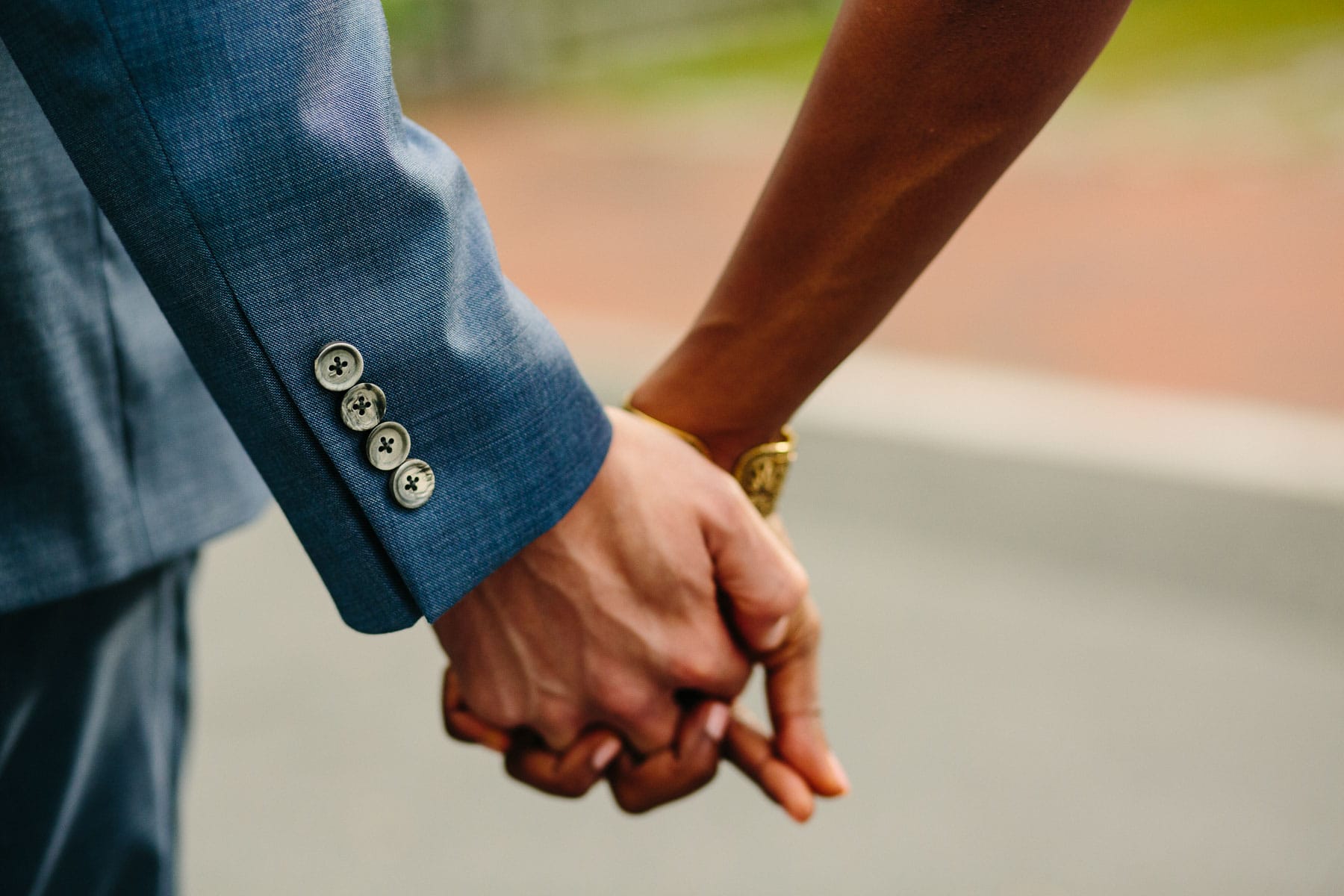 detail of bride and groom holding hands | Kelly Benvenuto Photography