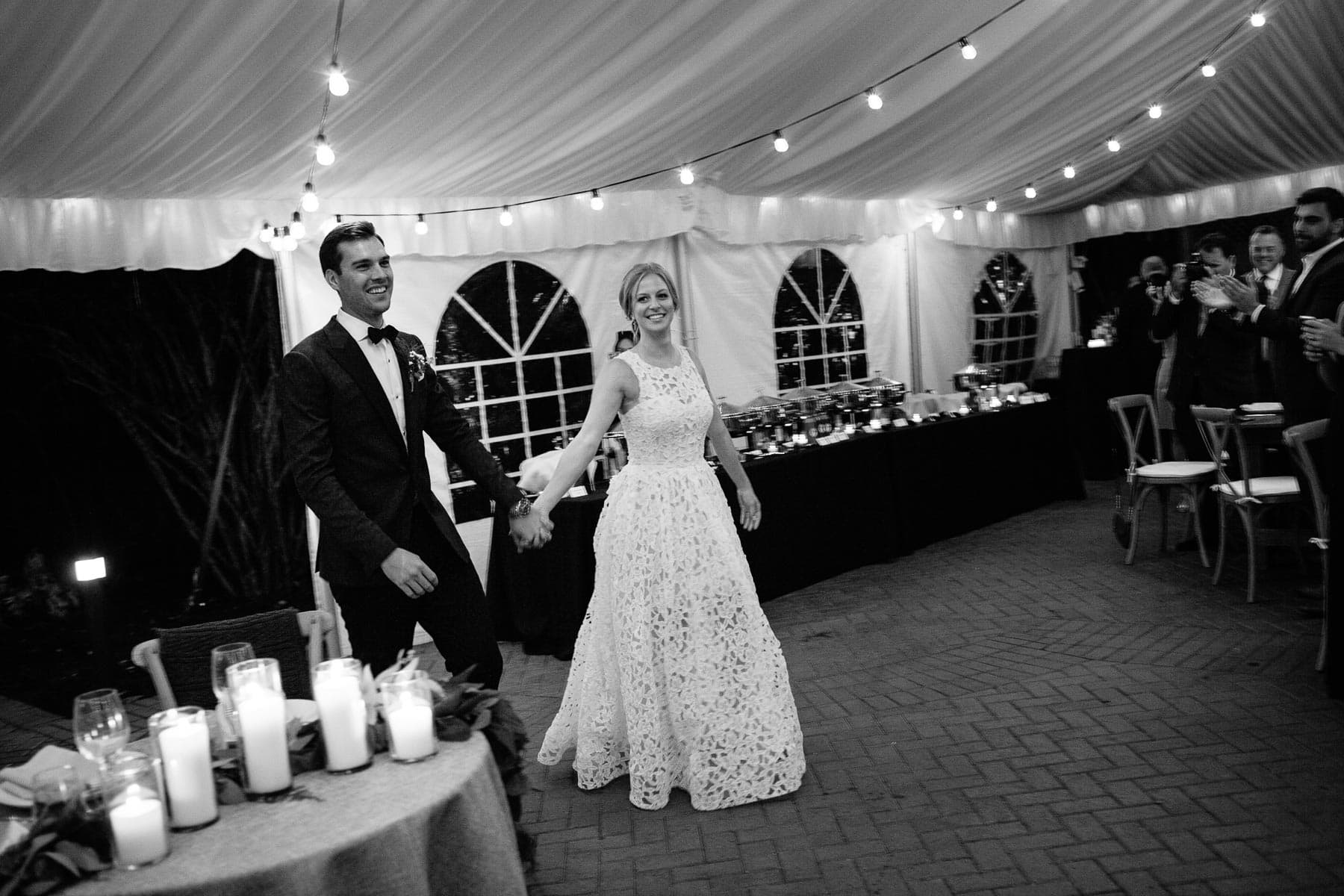 bride and groom enter tent for reception | Kelly Benvenuto Photography
