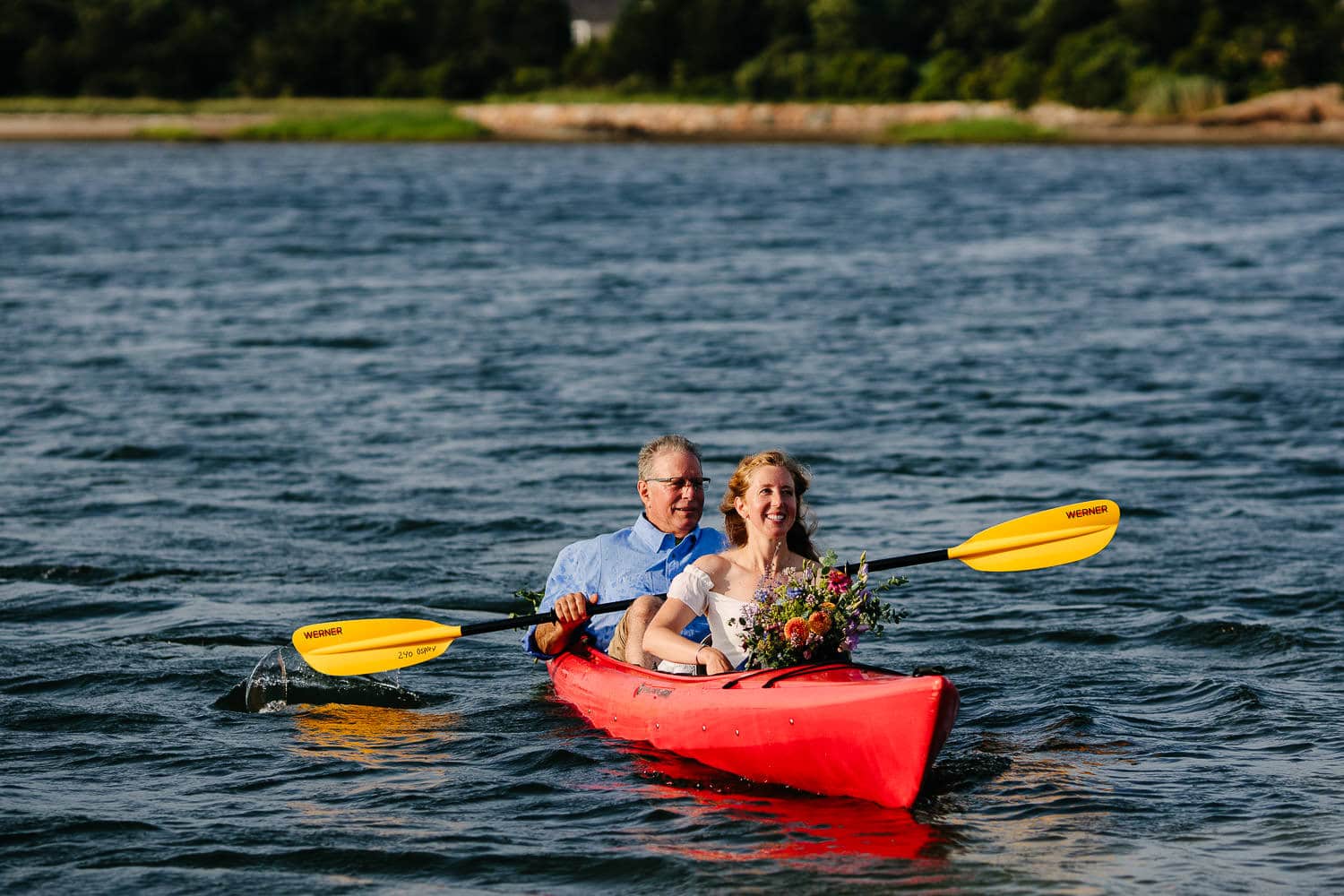 bride kayaking with father
