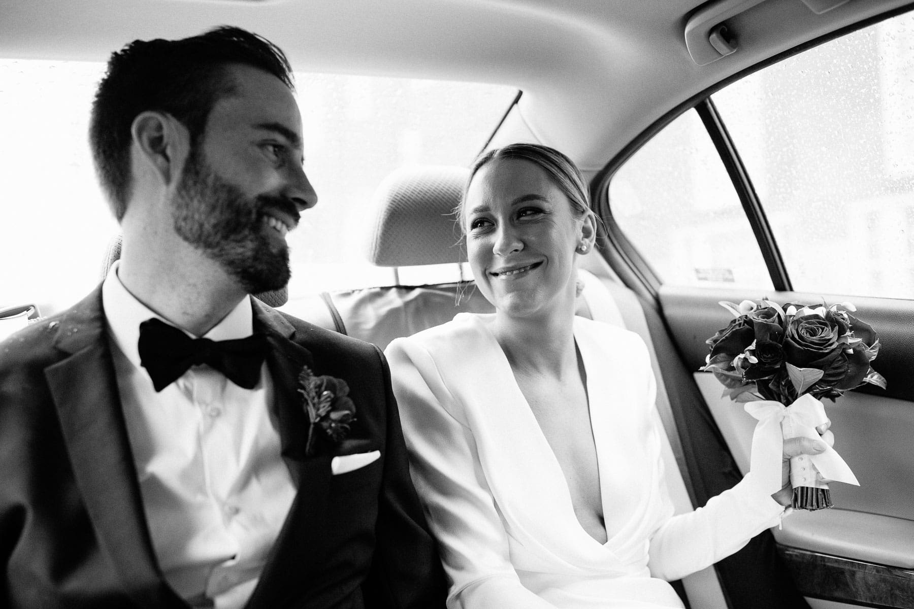 bride and groom in a cab