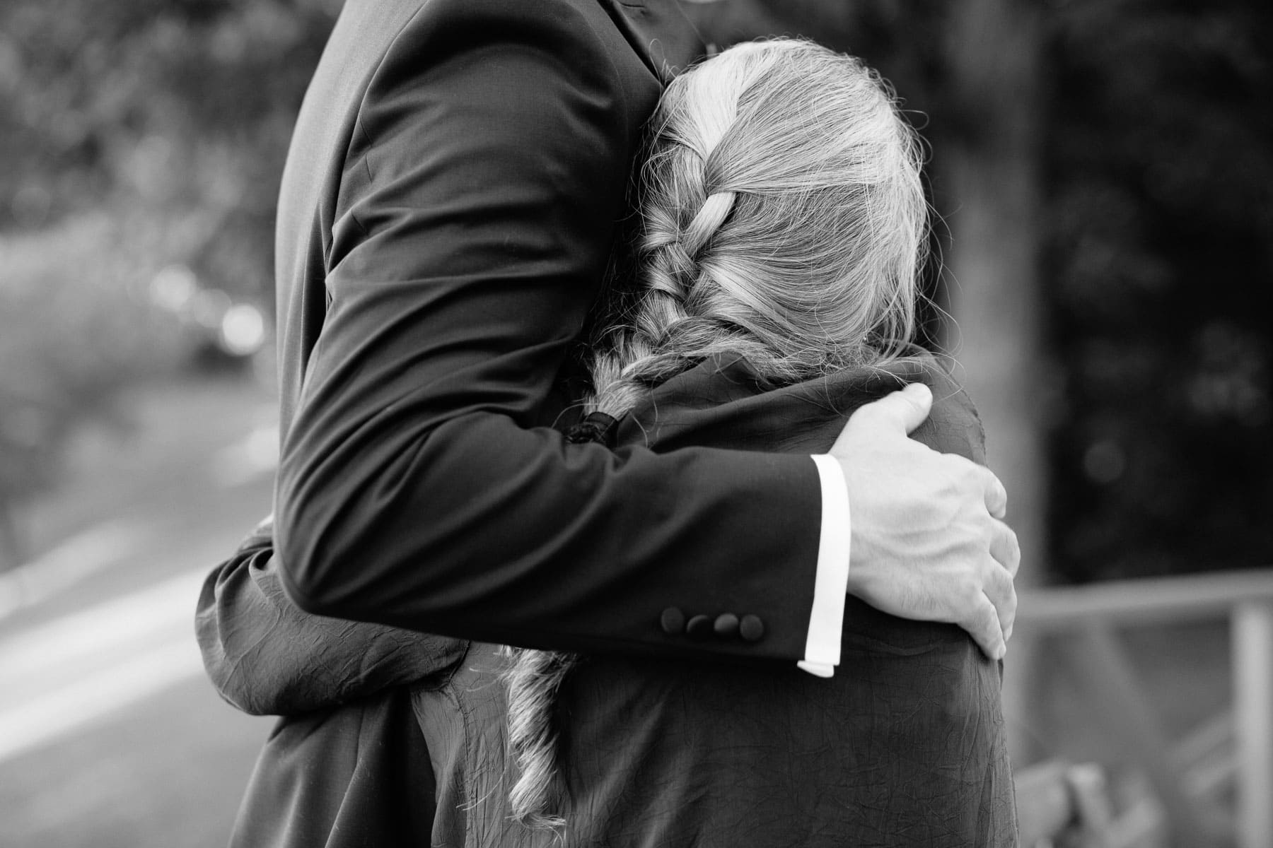 mother of the groom hugs her son