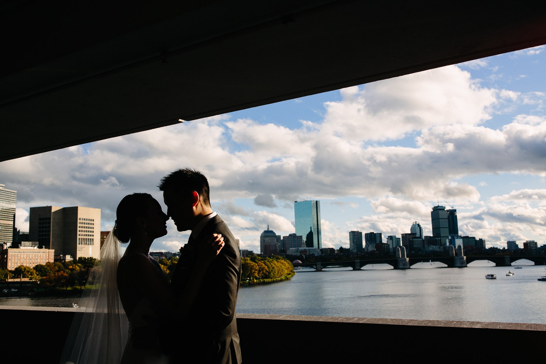 bride and groom with the Boston skyline