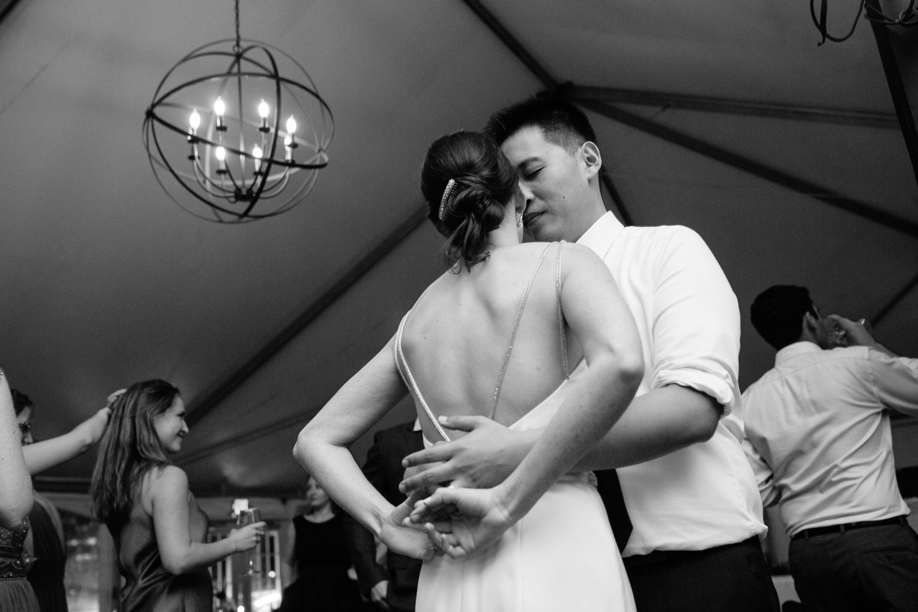 bride and groom dance at their wedding in the tent at the Boston Museum of Science