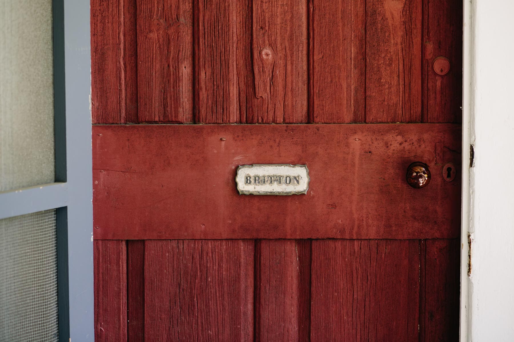 family name plate on red door
