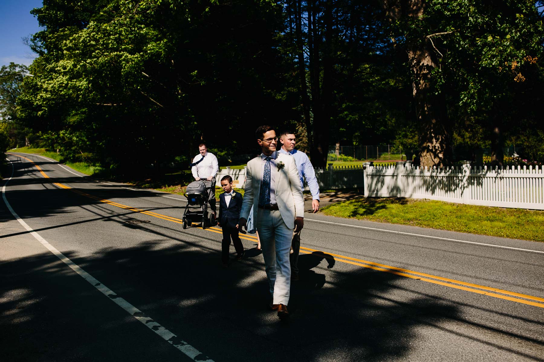grooms walks to church for wedding ceremony, Kent, Connecticut