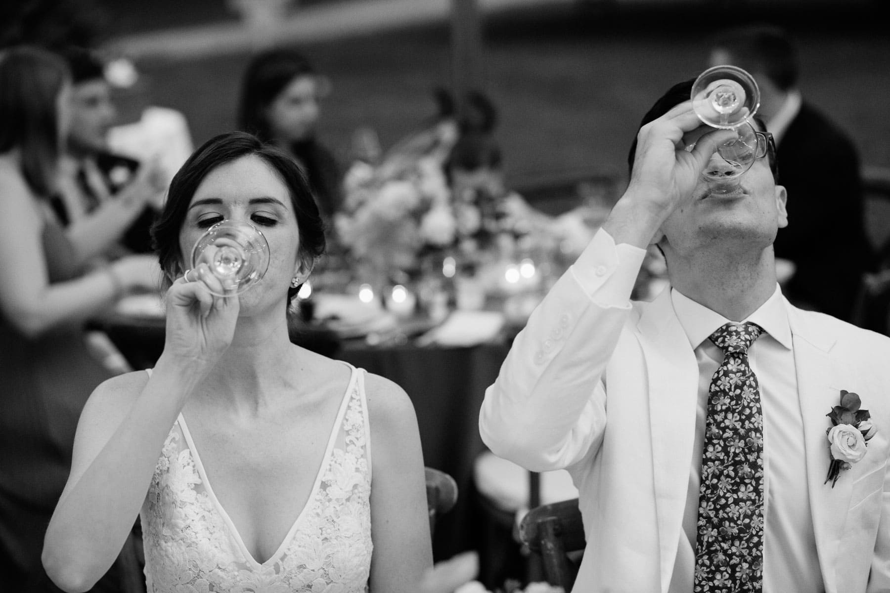 bride and groom drink wine
