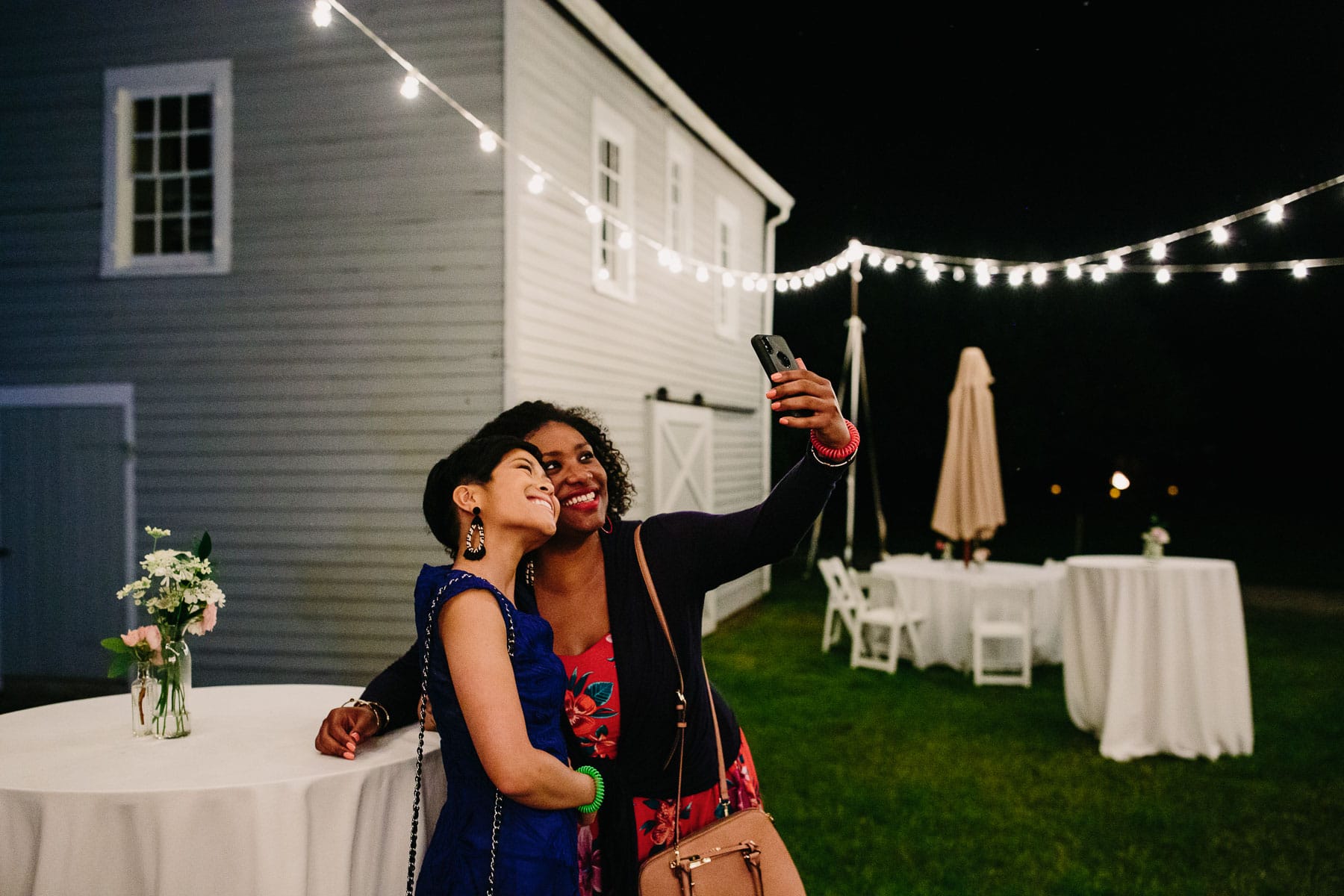 guests take a selfie under bistro lights, backyard Kent Connecticut wedding
