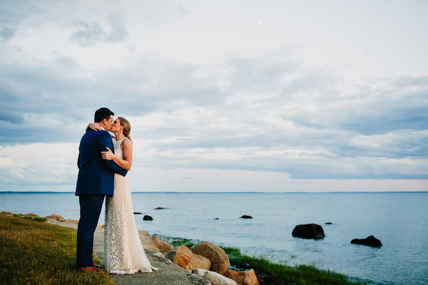 couple kiss on rocky coast of Massachusetts