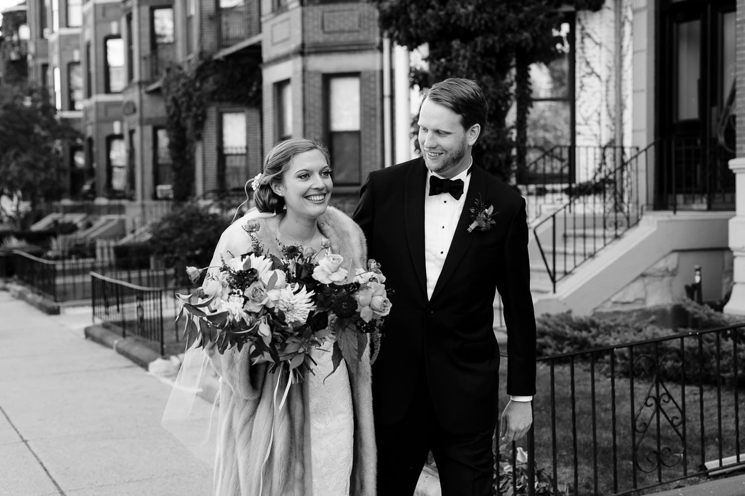 black and white image of bride and groom on Commonwealth Avenue in Boston, near the Harvard Club
