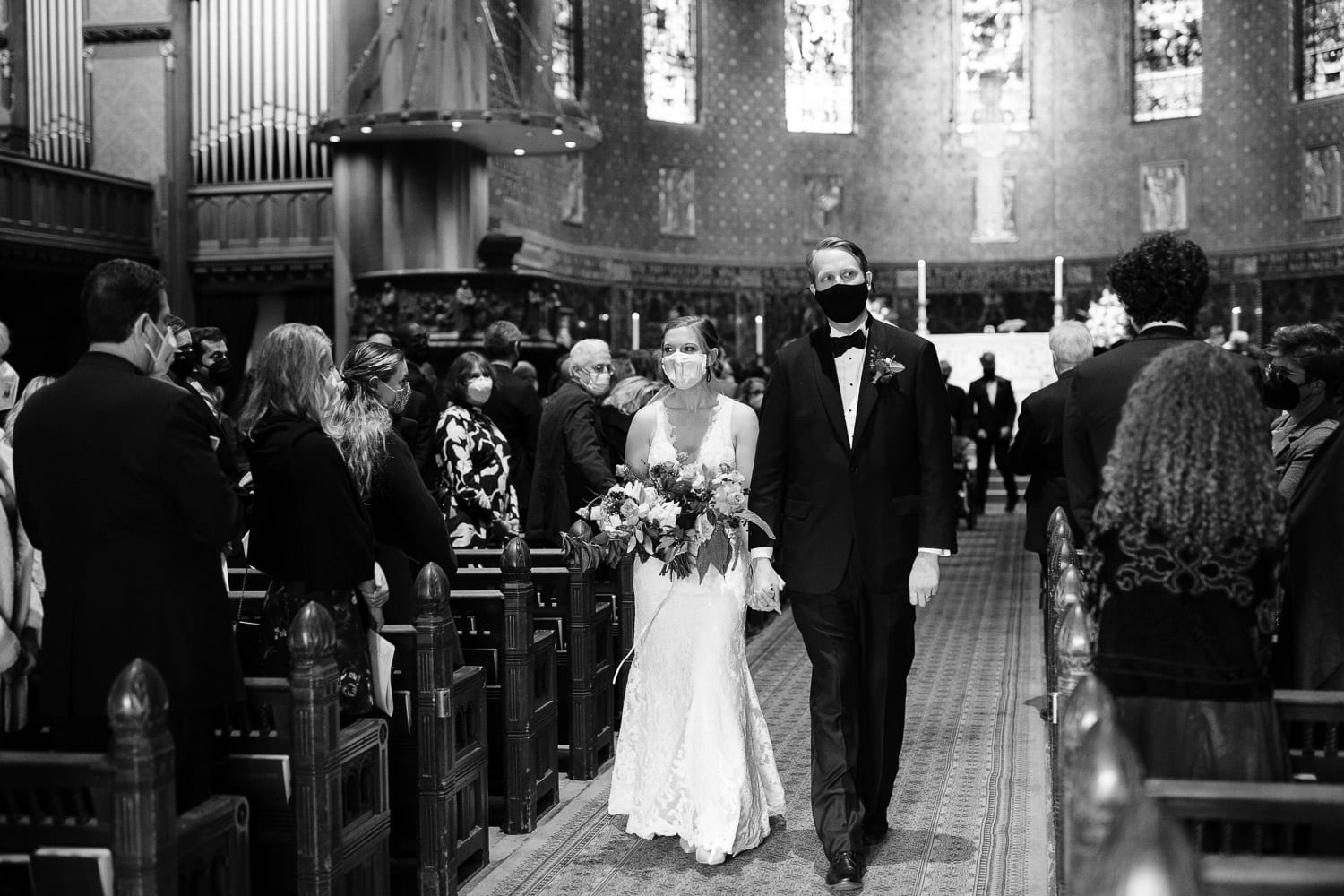 black and white image of bride and groom coming up the aisle of Boston's Trinity Church