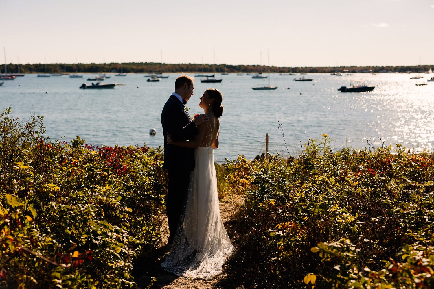 portrait of a bride and groom on the water at their Mattapoisett wedding