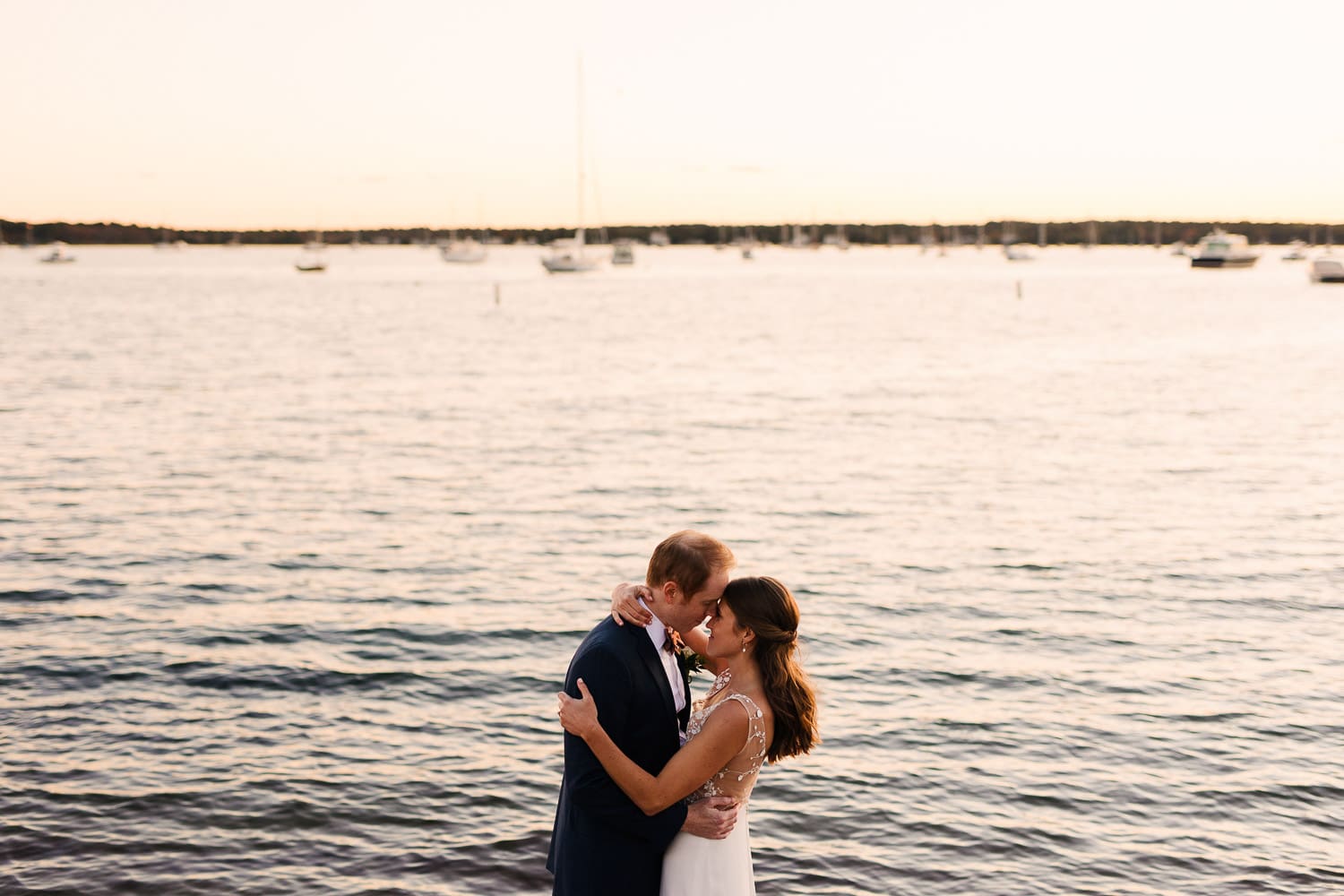sunset portrait of bride and groom on the water in Mattapoisett